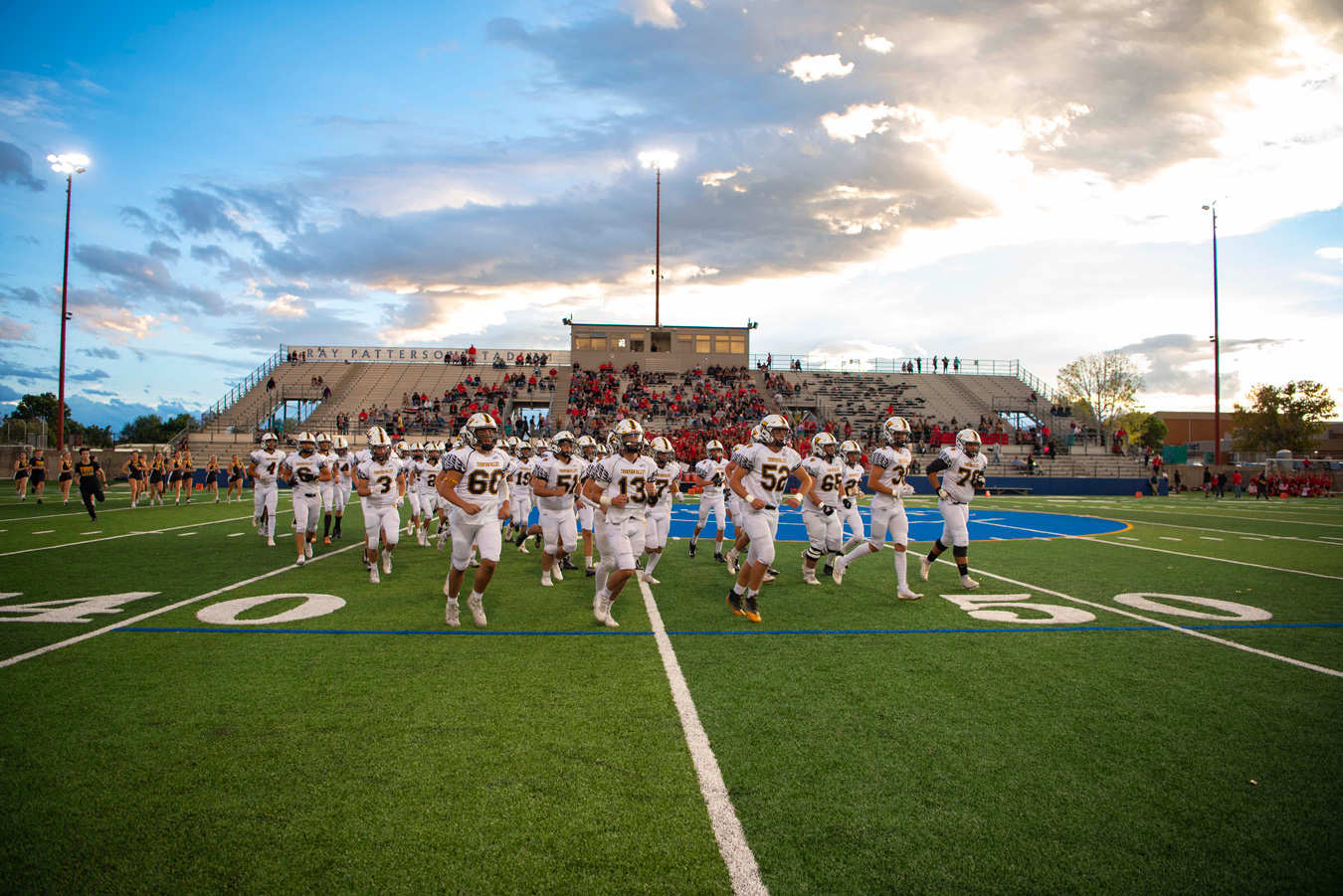 football team running onto field at sunset Misty Huss Photography SP21177