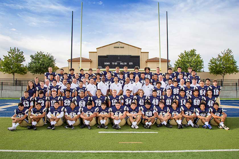 high school football team with coaches
